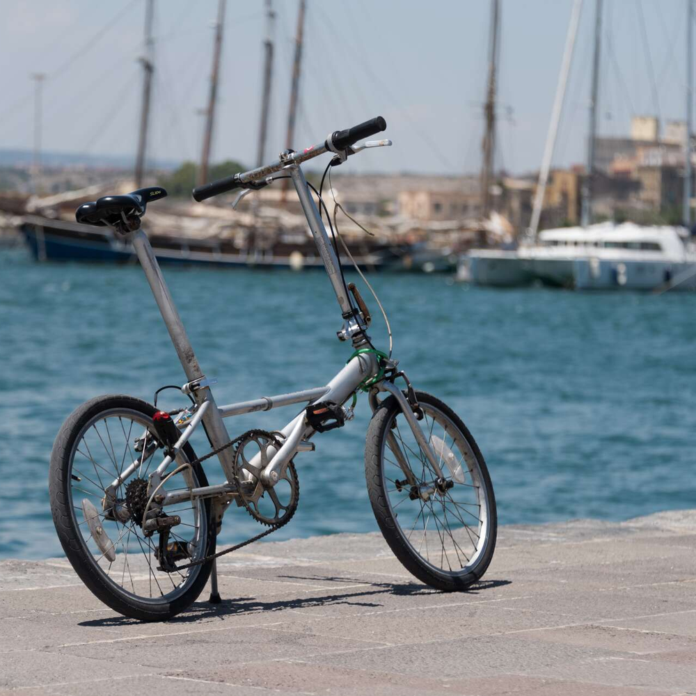 Fahrrad und Meer: 7 Tipps für Urlaub mit Rad und Boot Ein Faltrad im Hafen bei Sommerwetter