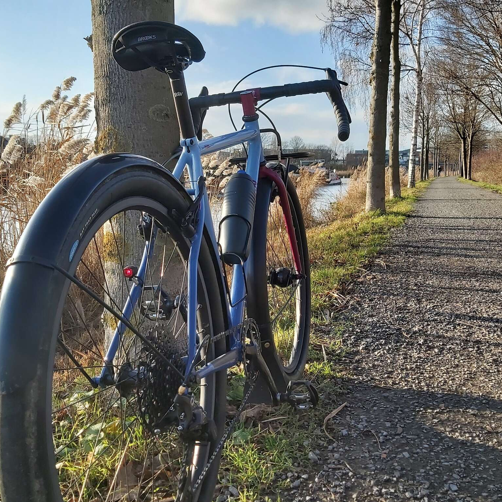 Gravel Bike - der sportliche Allrounder Ein Gravel Bike von hinten fotografiert auf einem Schotterweg bei sonnigem Winterwetter..