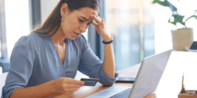 So entlarvst du einen E-Bike Fakeshop Frau verzweifelt vor Laptop wegen eines Fake-Shops