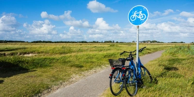 Zwei Fahrräder stehen auf einem Radweg