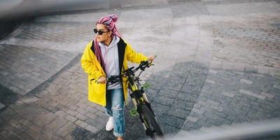 Junge Frau schiebt E-Bike