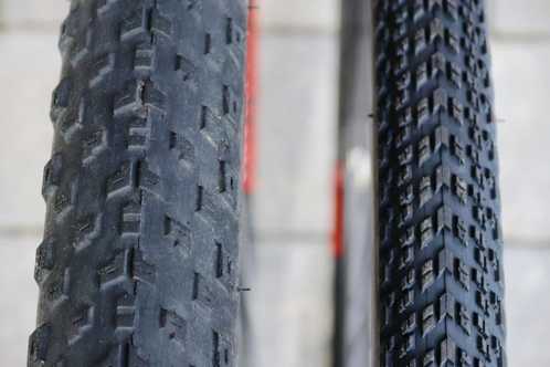 Nahaufnahme von zwei verschiedenen Fahrradreifen mit unterschiedlichen Profilen.